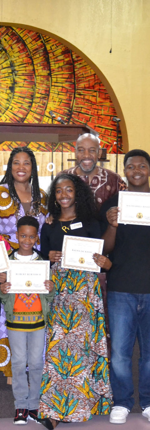 Group of people holding certificates at an award ceremony