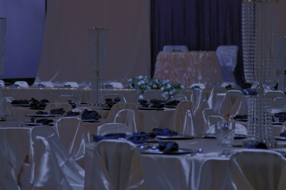 Elegant event hall setup with tables, chairs, and centerpieces