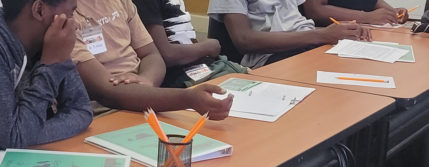 Students attentively seated at long table during class