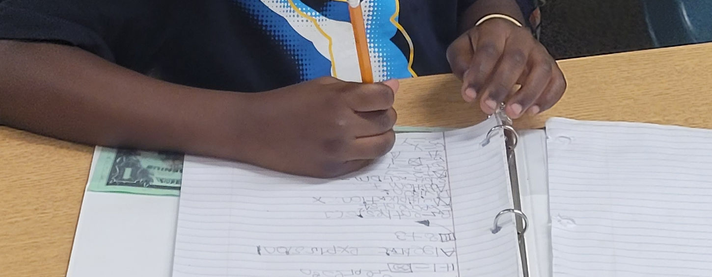 Young boy diligently works on class assignment