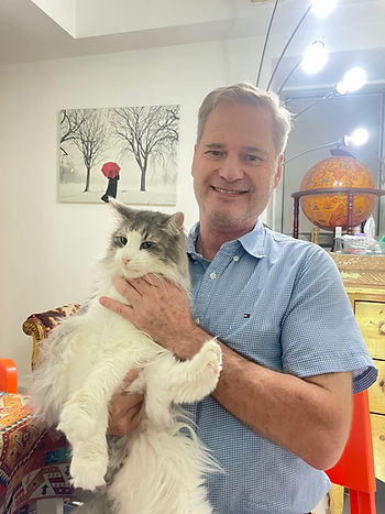 Dr Gerry Pahl conducting pre-flight health check on Solo, a diabetic Norwegian Forest Cat, at his home in Hong Kong