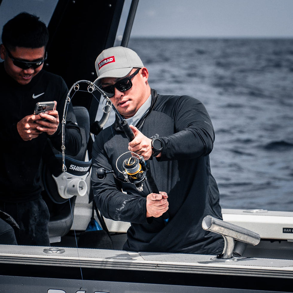 Angler holding a large kingfish caught on a Sydney sport fishing charter