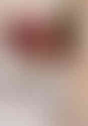 pink and red wedding bouquet with white heels in churhc window