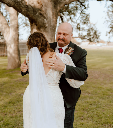 dad hugging bride