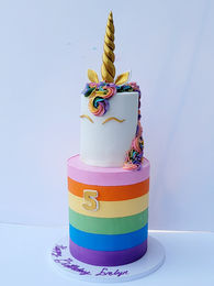 Custom 2 tier unicorn birthday cake with rainbow for a 5 year old girl