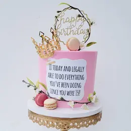 Buttercream birthday cake with flowers and macarons