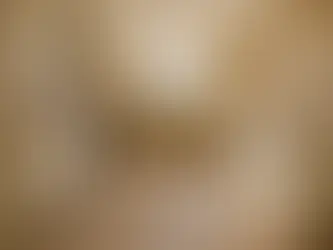 Renovated kitchen with cream cabinets, exposed drywall, and tools on tiled floor. Sunlight through window creates a warm, unfinished look.