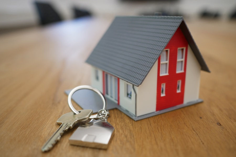 Miniature house model with keys representing UK property mortgage assessment