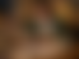 A young UK first time buyer working on a laptop in the evening with receipts and a coffee