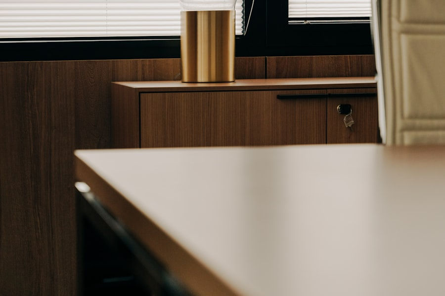 A GP consulting room early in the morning, empty chair and desk lamp on