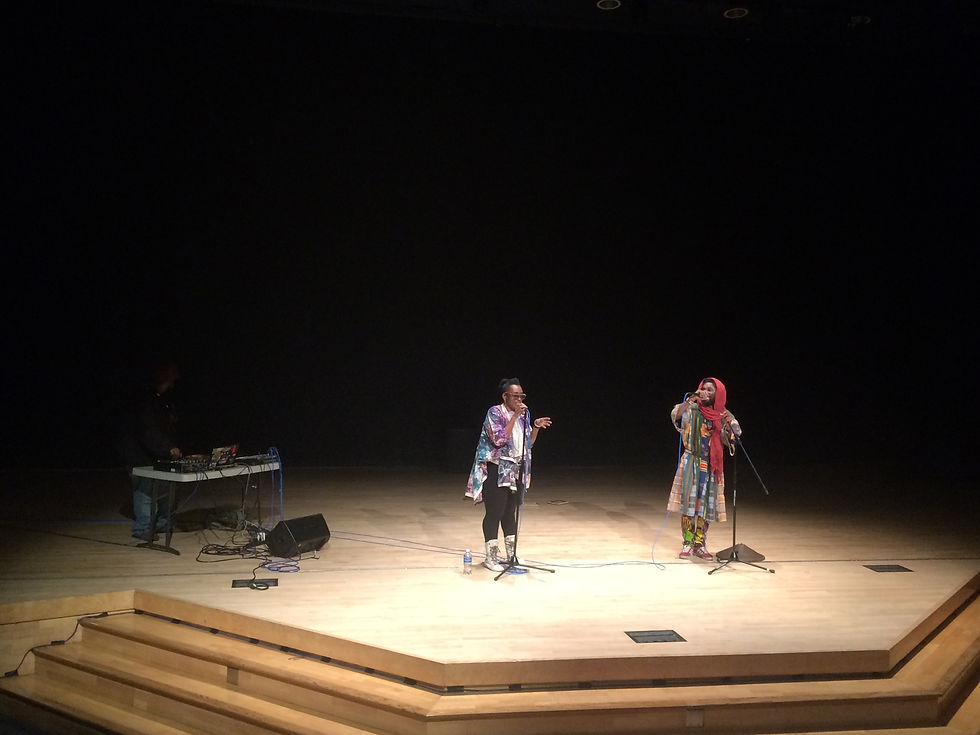 Ras_G, Nebula, and Sadiq rapping and moving to the engineered music. Photo, Emily Santiago-Molina