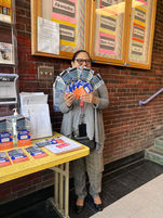 BPS Parent and CPLAN Member smiles while holding the new Boston Public Schools Family Resource Brochures that CPLAN designed and printed