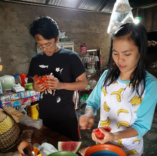 PDD Week 1 Riz finish packing the juice into the plastic while the cadre is cutting