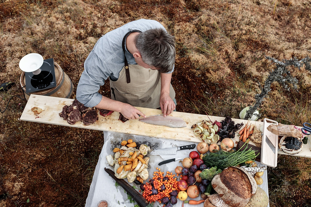 man preparing food in the wild