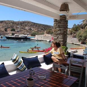 Woman looking out over kayaks and boats in harbour