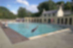 A woman diving in to Cleveland Pools