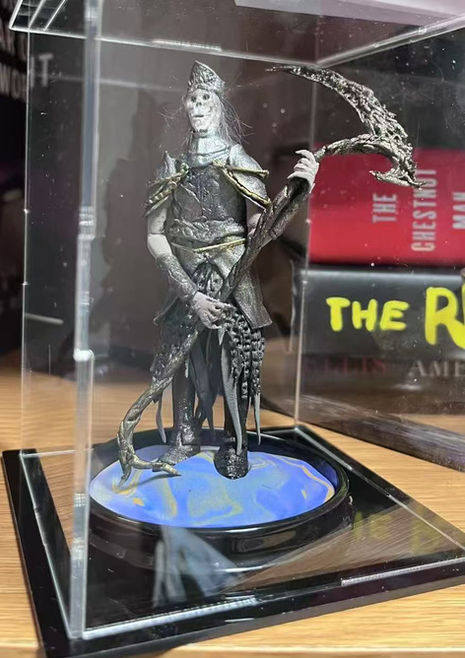 A thin and tall game character Pontiff Knight from dark souls 3 game made from air dry clay.