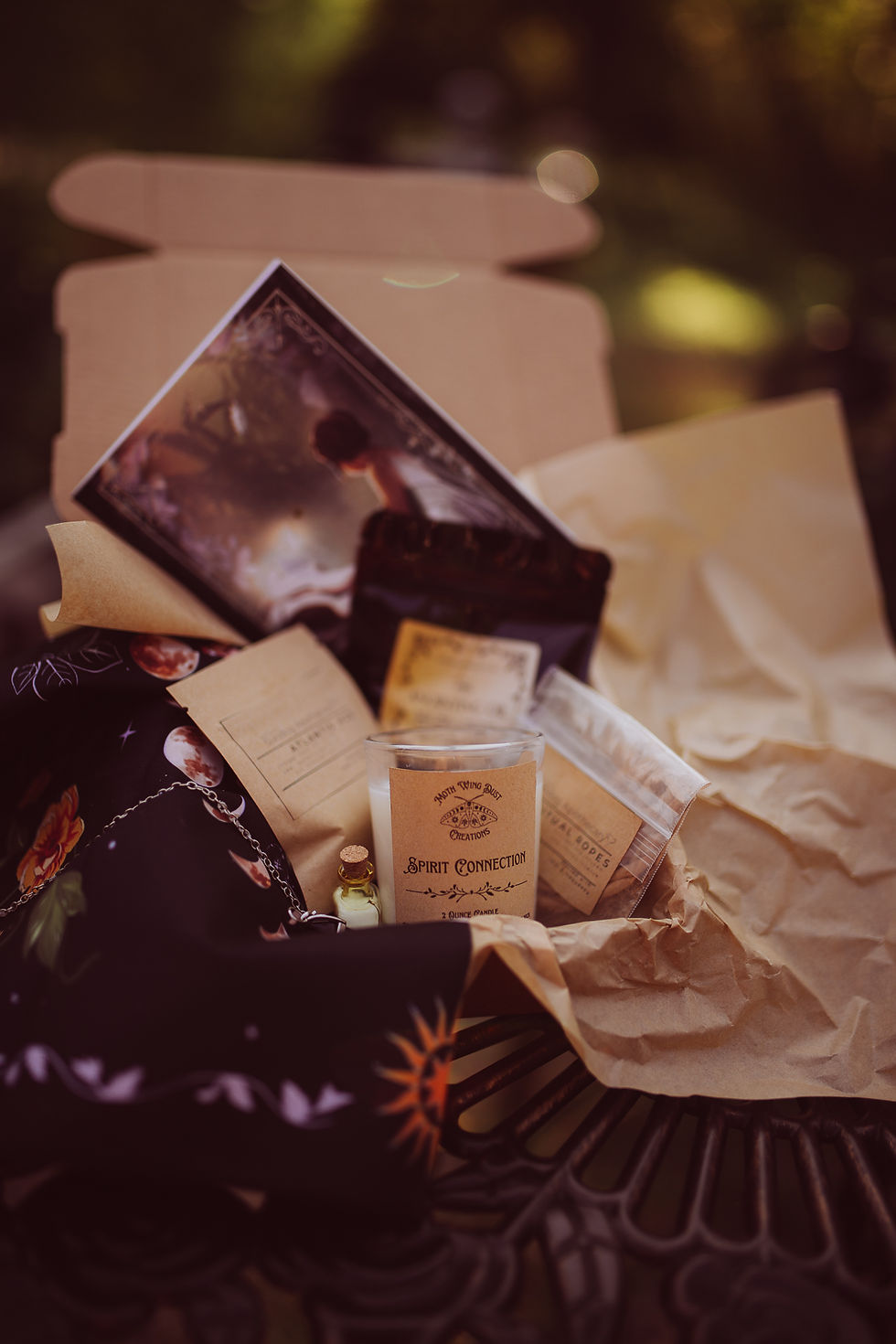 The Prophecy Parcel with a candle and various semi-hidden ritual items sticking out of a box