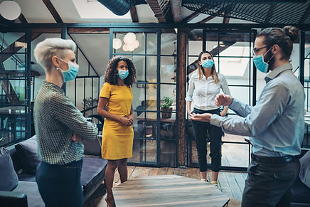 Colleagues navigating a difficult moment together — representing the real-world conditions that threaten leadership authority, addressed through coaching for managers.