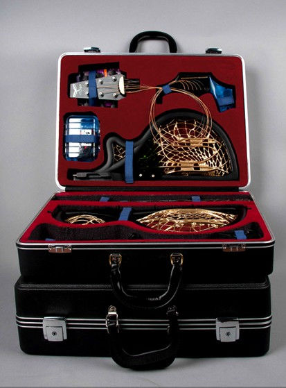 Rigdewing guitar shown in open case seated upon a second closed case