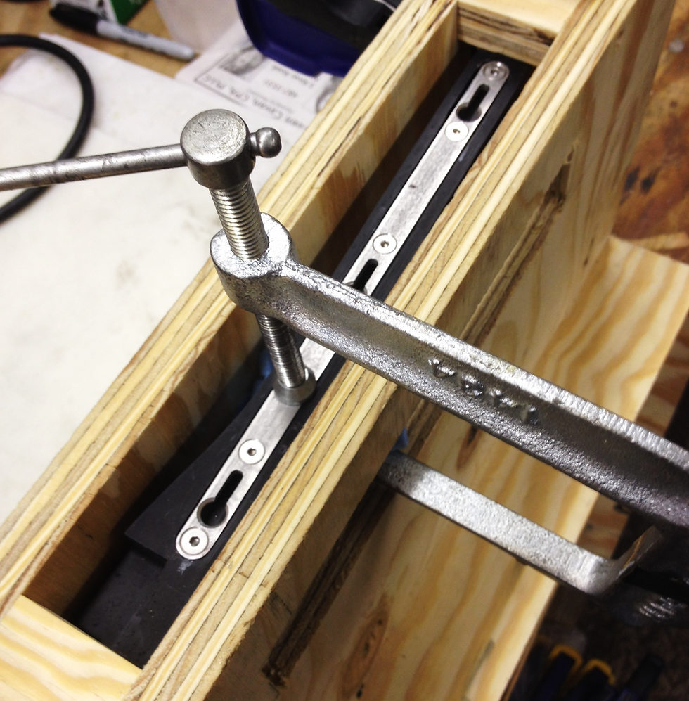 Attaching the stainless steel frame-joining bracket to the inside face of the treble frame