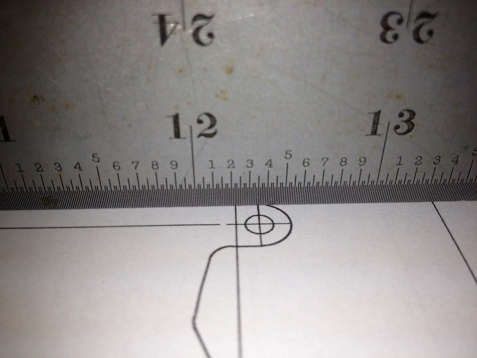 A ruler is being used to verify the dimensions on a CAD drawing printed out from an office printer to a precision 1/100 inch