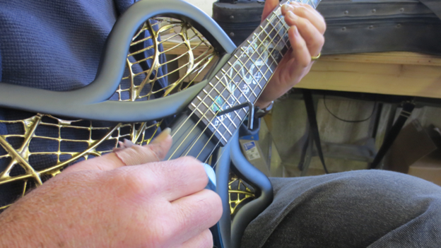 Harvey Reid adjusts the neck angle while playing