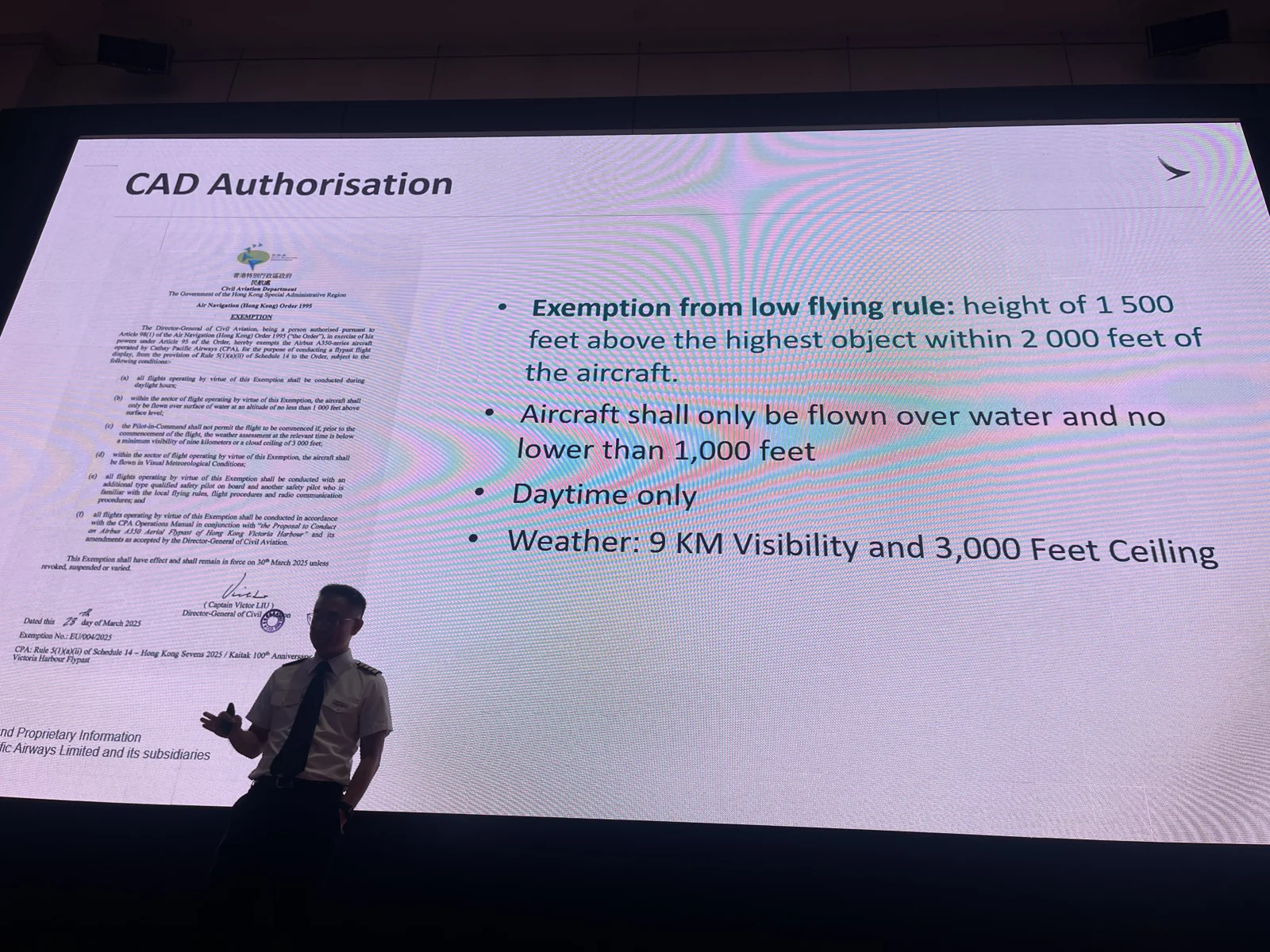 A speaker discusses a projected slide headed CAD Authorisation.