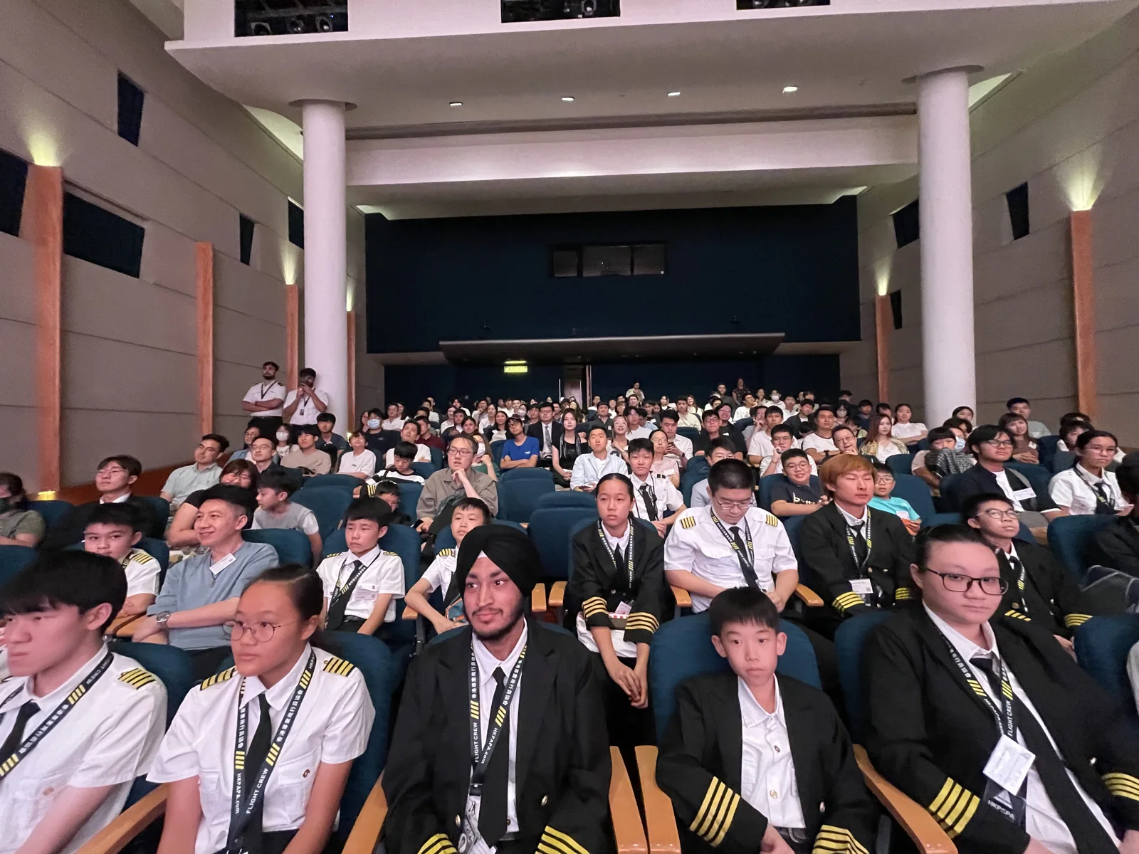 Rows of young participants seated in the auditorium during the aviation seminar.