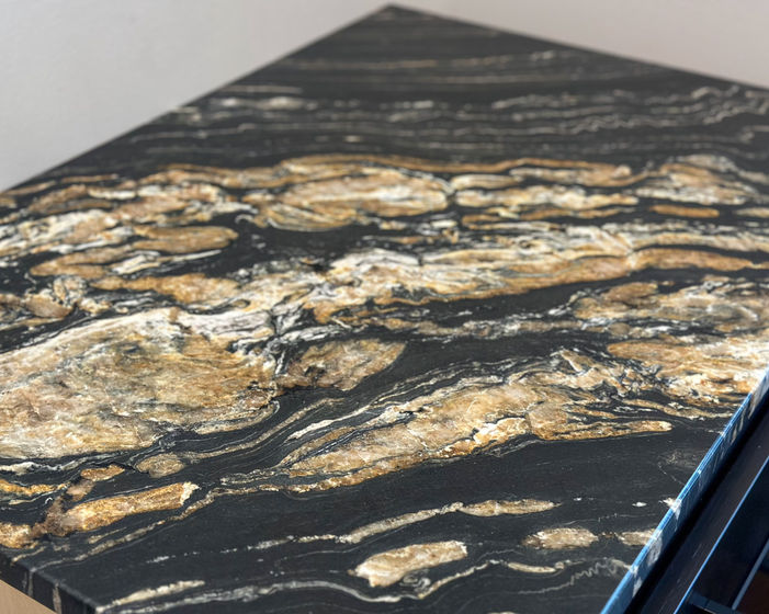 Black granite countertop with beige veining.