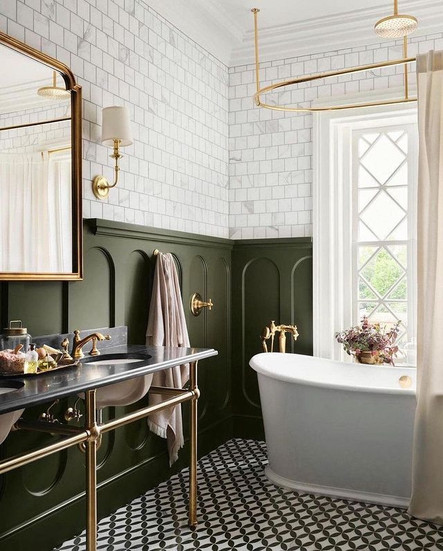 Joanna Gaines designed bathroom for their castle project featuring green pill shaped wall moldings and vintage inspired finishes