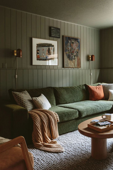 Emily Henderson design featuring a dark green room paired with a green corduroy couch