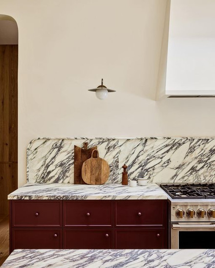 Sarah Sherman Samuel #sssshowhouse featuring red cabinets and heavy veined backsplash and countertops