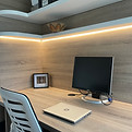 Custom-built home office with integrated LED lighting and wood-effect panelling – bespoke workspace. East Molesey, Surrey
