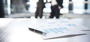Documents and Blurred Business Men