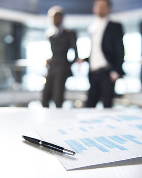 Documents and Blurred Business Men