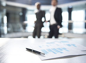 Documents and Blurred Business Men