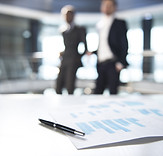 Documents and Blurred Business Men