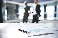 Documents and Blurred Business Men