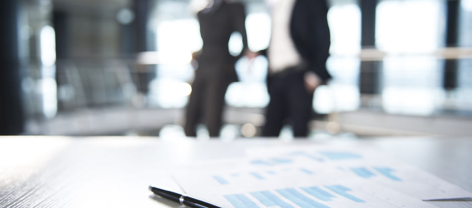 Documents and Blurred Business Men