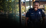 Female officer smiling, a career at Irving PD is a great choice