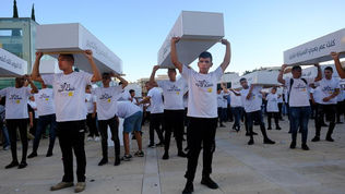 Arab teenagers hold coffins at a protest against crime in Arab society
