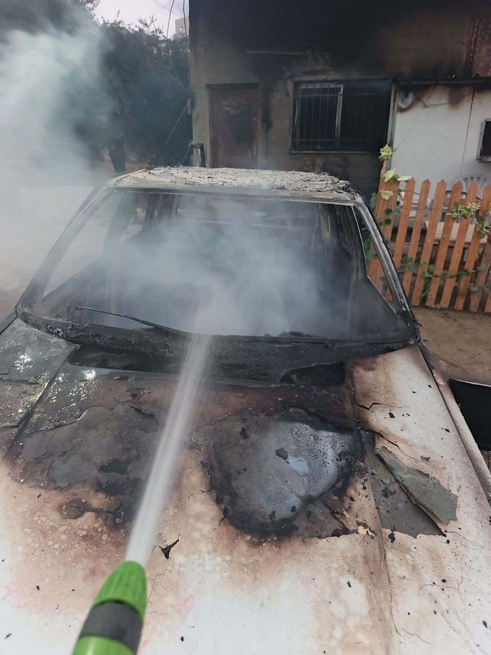 A torched car in the village of Urif. Photo courtesy of residents.