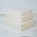 stack of the best wedding dress preservation in saint louis with muslin slips in three sizes