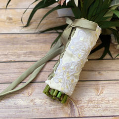 ivory satin with white lace bouquet wrap around stems of green bouquet with sage green satin lacing ribbon