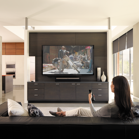 Woman watching TV with Audio Video Systems