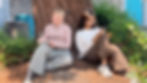 Two students sitting outdoors in conversation during reflective activity