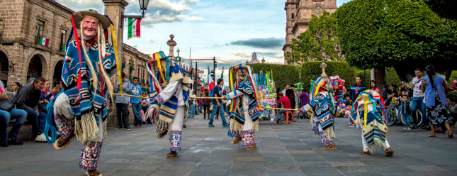 Group of Performers Dancing Near Trees.png