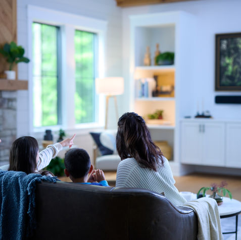 Family watching TV in a living room