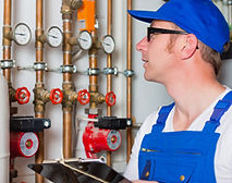 Technician installing and servicing heating and cooling systems